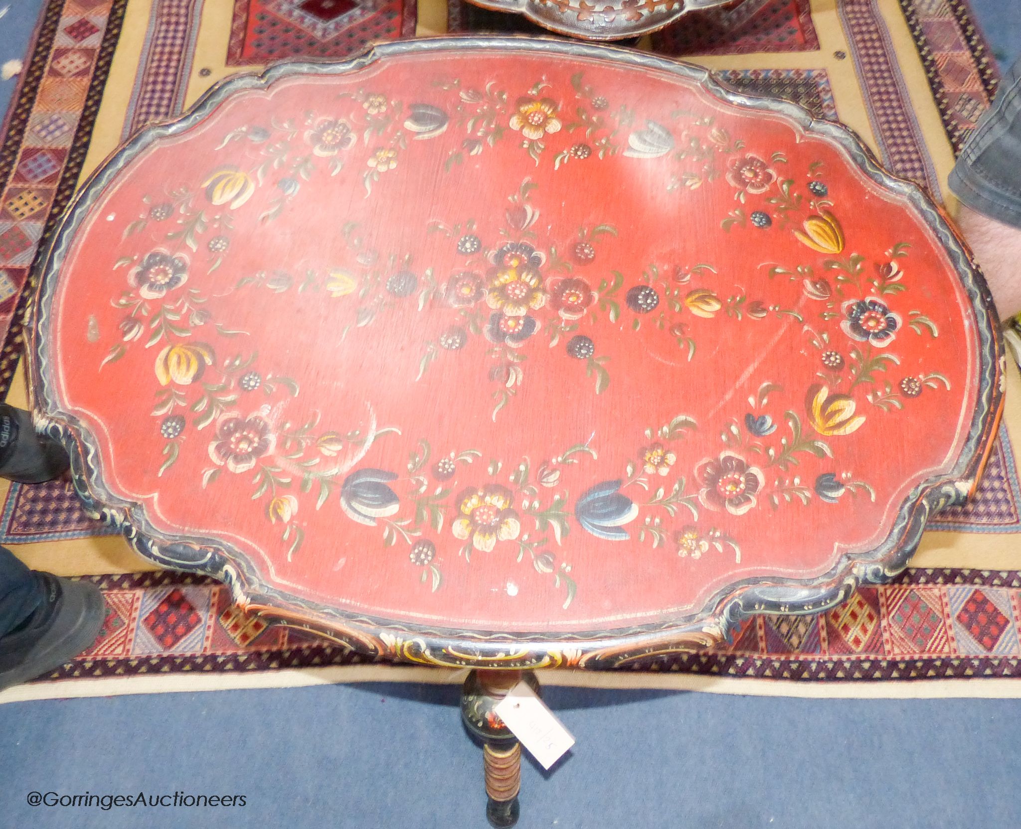 A 19th century Swiss painted folding table, 75 cm long, 56 cm deep, 62 cm pine, the underside with carved heads and painted religious scene